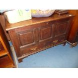 A dark Oak Mule Chest having three raised and fielded panels to the front with two short drawers