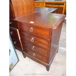 A Stag dark Mahogany bedside chest of four short drawers,