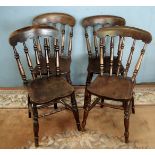 A set of four solid Elm seated Welsh design kitchen Chairs having turned legs,