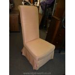 An Edwardian high back Nursing Chair having turned front legs and peach/pink coloured upholstery