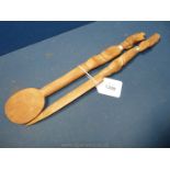 An African carved wood fork and spoon set with anthropomorphic handles,