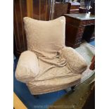 An Edwardian design Fireside Chair having green upholstery and later beige loose cover,