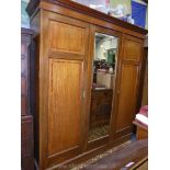 A good quality Edwardian cross-banded and light/dark wood strung Mahogany triple Wardrobe having to