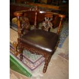 A good Oak & Mahogany Corner Elbow Chair having backrest rail profusely carved with the face of a
