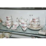 A Royal Albert 'Moss Rose' tea service for eight, plus bud vase and chamber stick.