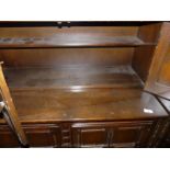 An Ercol dark wood six drawer shelved dresser.