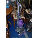 A purple Dyson vacuum cleaner.