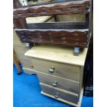 A bedside flight of three drawers and a wooden magazine rack.