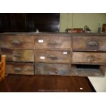 A wall hanging pine nine drawer unit (one drawer missing) 4' 6 1/4" wide.