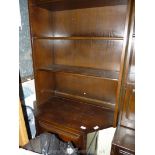 An Ercol dark-wood corner dresser.