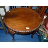A small round Mahogany coffee table with pie-crust edge and cabriole legs.