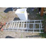 A sectional extending aluminium ladder in 6 sections with a total of 20 rungs and a tub of