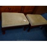 A pair of matching foot stools with green velvet covers.