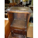 An Oak bedside cabinet with linen-fold detail to the door.