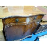 A serpentine fronted Mahogany drinks cabinet.