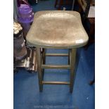 A green stained vintage bar stool.