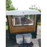 A single axle trailer with roof cover and windscreen, possibly suitable for tractor road run use.