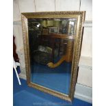 A gilt mirror with bevelled edge.