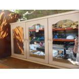 A cream three mirrored bathroom cabinet.