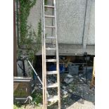 An extending wooden ladder, 22 rungs total.