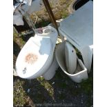 Toilet and damaged cistern and lid.