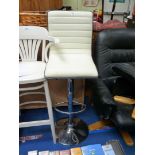 A chrome and white faux leather bar seat