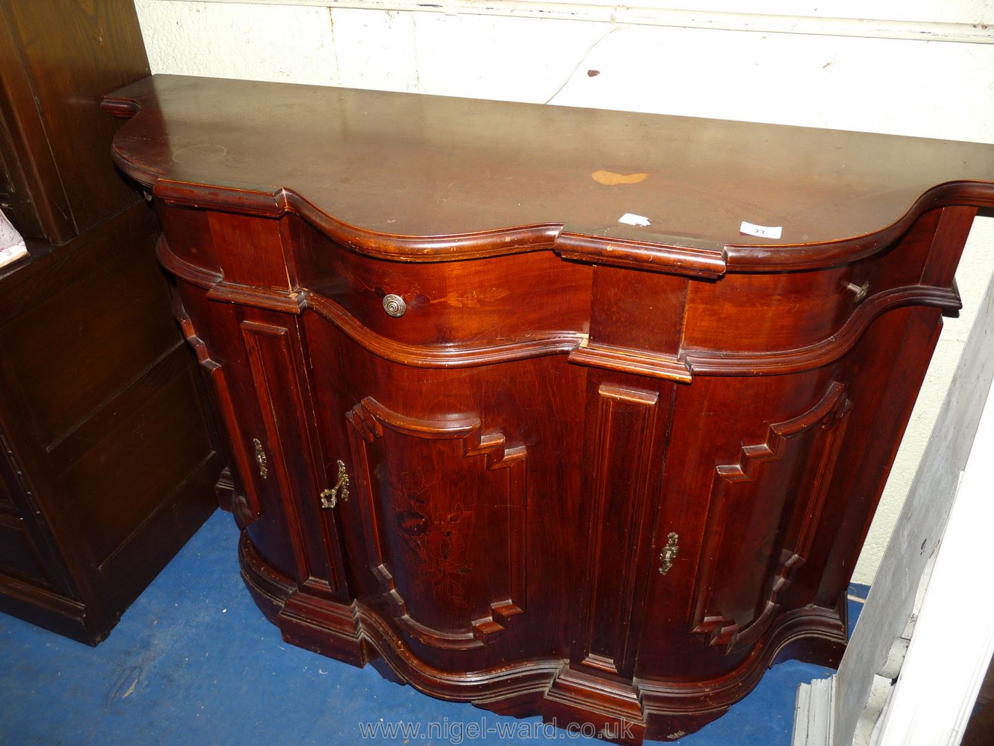 A reproduction bow-fronted sideboard.