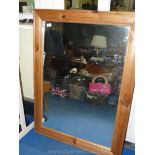 A large pine framed mirror 108 cm x 58 cm.