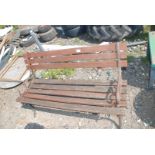 A wooden bench with cast iron supports.