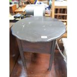 A black sewing table/work-box with pink fabric lined interior and standing on square legs.