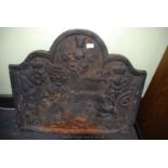 A heavy cast iron fire back.