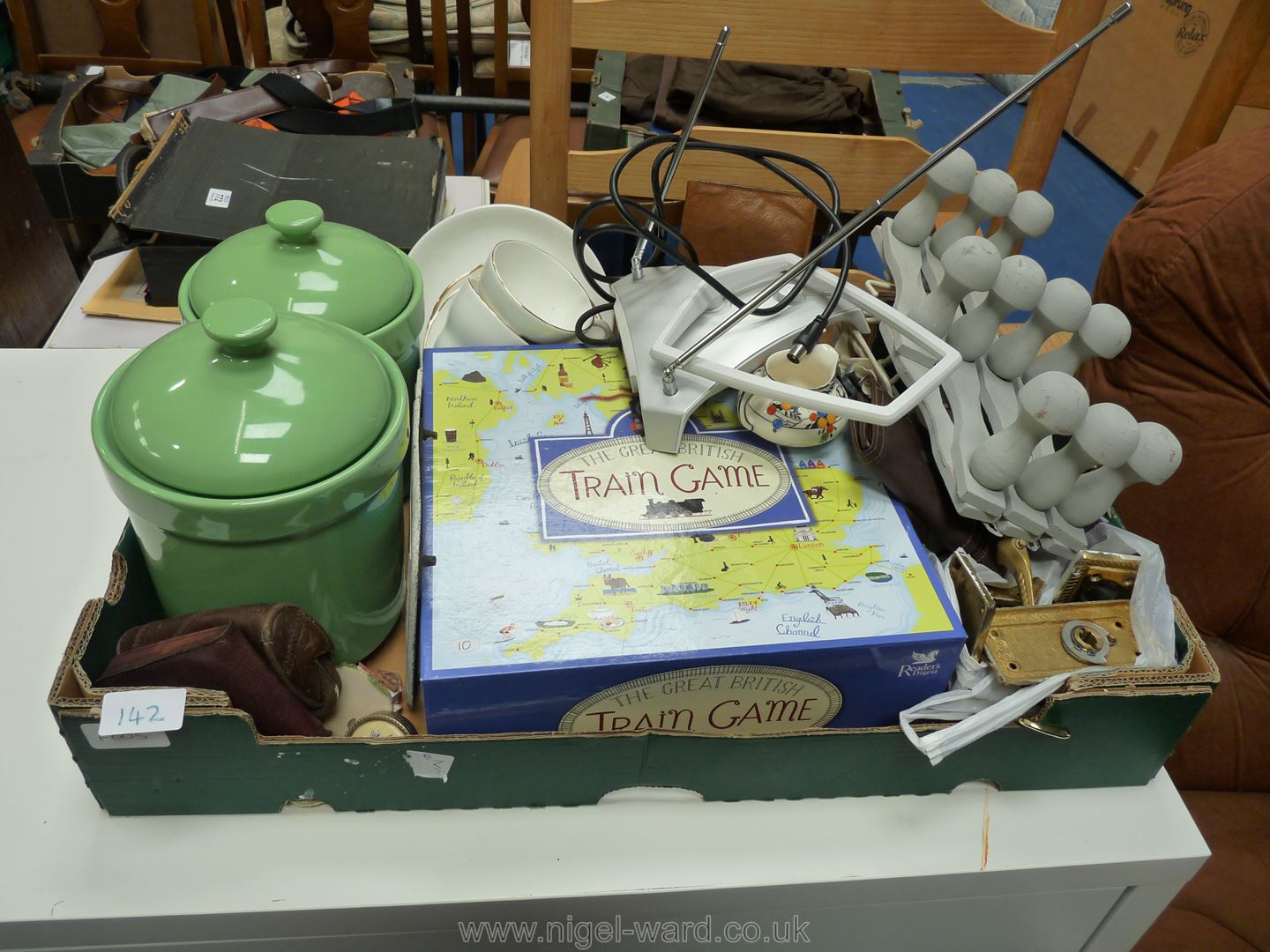 A box of ornaments, train game and kitchen canisters.