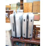 Two modern "Constellation" lightweight silver/chrome-coloured suitcases on castors.