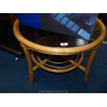 A glass top bamboo table, circular.