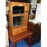 A small pine kitchen shelf unit with a drawer and a dark-wood coffee table.