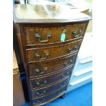 A cross-banded and bow-fronted reproduction tall-boy chest of six short drawers.