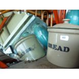 A stone bread bin and a mirror.