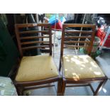 A pair of oak dining chairs.