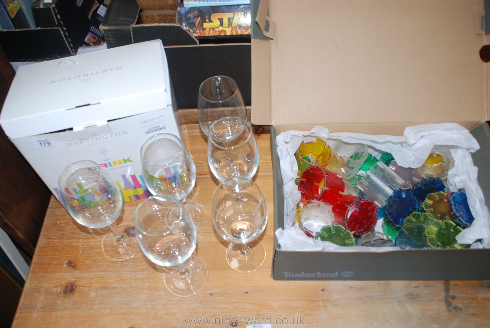 A box of Dartington crystal mixed wine glasses and perspex sculpture