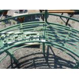 A semi circular metal garden seat.