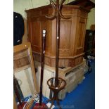 A bentwood hat & coat stand and a dark-wood standard lamp, no shade present.