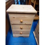 A three drawer pine bedside chest