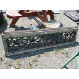 Two metal and wooden garden bench backs with trailing flowering stem pattern.