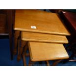 An Oak finish nest of tables.