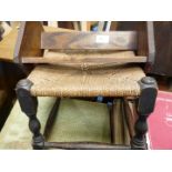 A small dark-wood framed Hessian/sea-grass seated foot stool and wooden book rack.