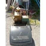 A petrol Briggs and Stratton petrol engined cylinder mower with grass collector box, 14" cut.