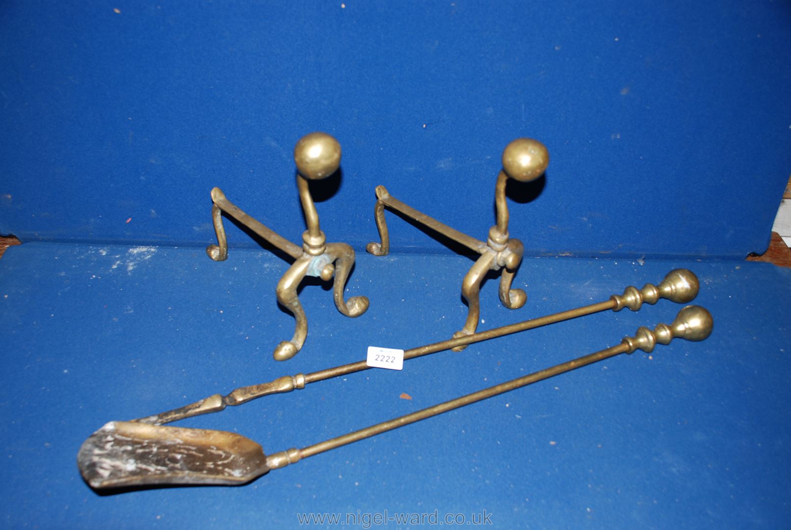 A pair of Brass fire dogs and a pair of fire irons