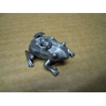 A pewter type metal frog earring and pendant set with an unique frog holder,