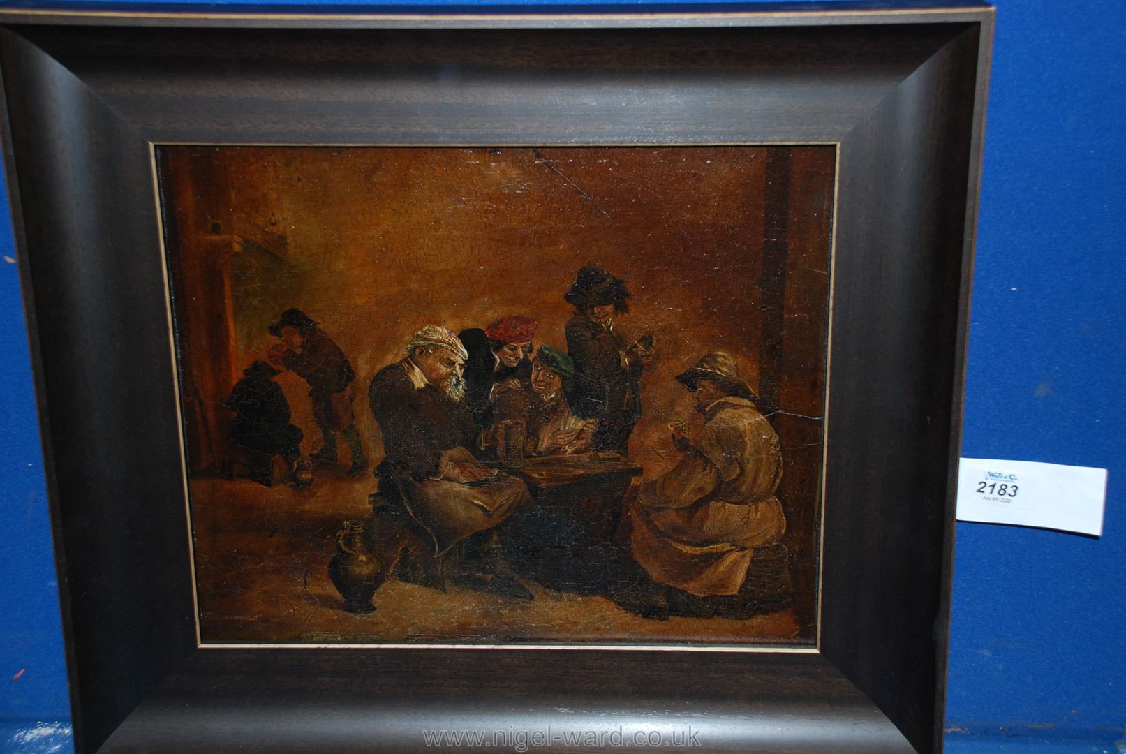 An Oil laid down on panel of topers playing cards in a tavern, in the manner of David Tenners.