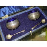 A cased pair of Silver Salts, Birmingham and spoons, complete with blue glass liners, case a/f.